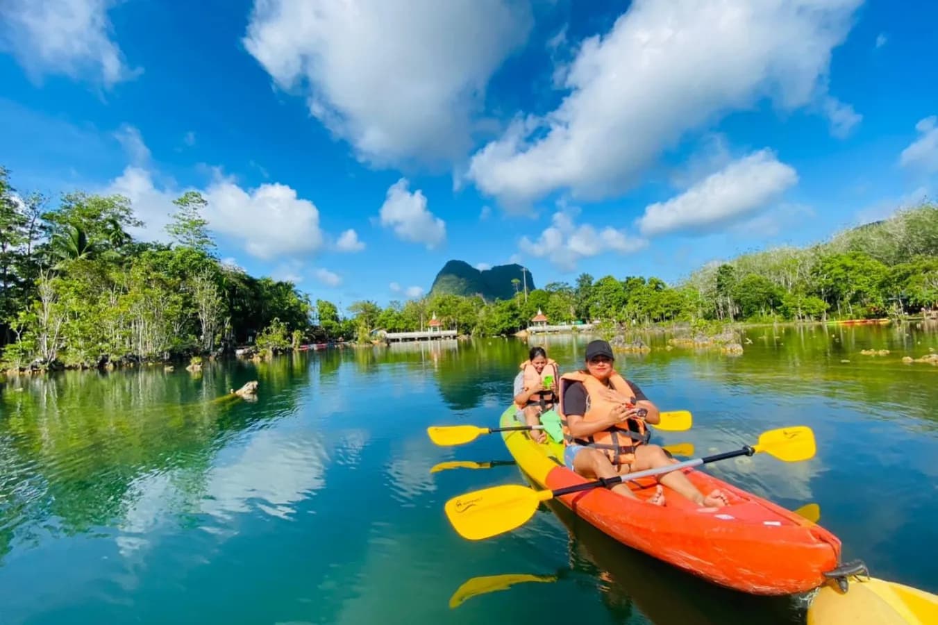 Kayakers on an emerald lake, representing the water sports offering
